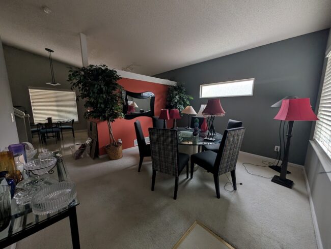Dining room with orange accent wall before repaint