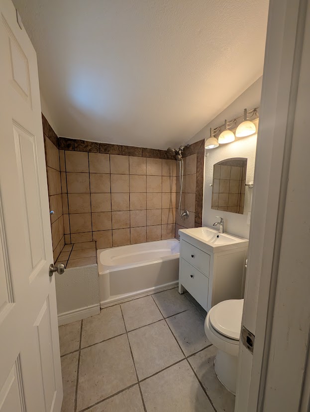 1913 bathroom before renovation with cracked tub and no storage
